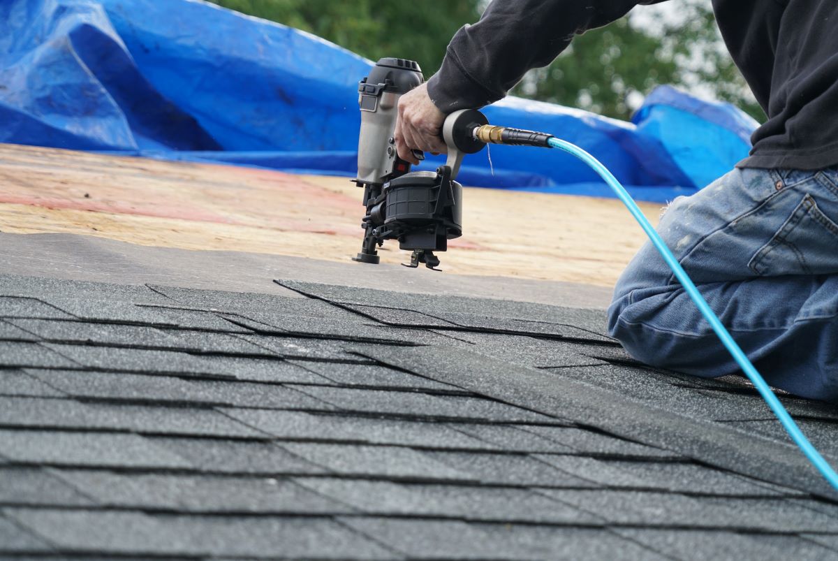 image of man working on roof